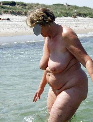Bare elder naturist at the beach.