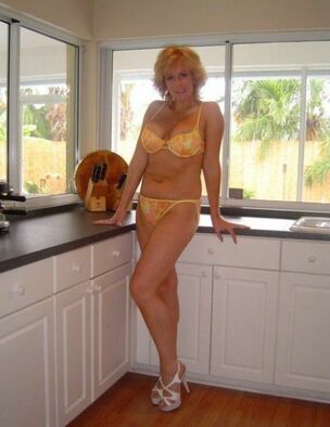 Blond Cougars posing at home in..